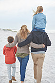 Family walking on winter beach