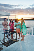 Friends barbecuing on summer houseboat