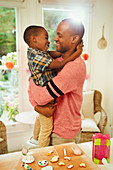 Father and son hugging next to Easter decorations