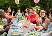 Family and friends enjoying birthday garden party