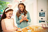 Mother and daughter colouring Easter eggs