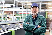 Portrait confident worker at conveyor belt