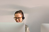 Smiling female telemarketer wearing headset