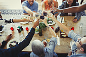 Overhead view friends toasting wine glasses