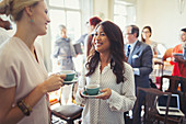 Businesswomen drinking coffee and networking