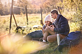Young couple hikers resting in grass