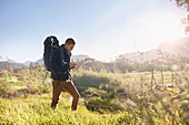 Young man with backpack hiking