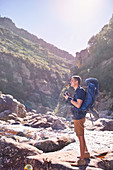 Young man with backpack hiking