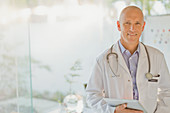 Portrait confident male doctor with digital tablet