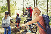 Portrait mother mountain biking with family