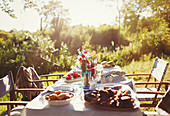 Food and flower bouquet on garden table