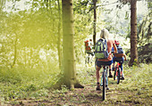 Family mountain biking on trail