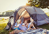 Mother and daughters talking and relaxing in tent