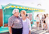 Smiling affectionate senior couple business owners