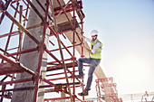 Construction worker climbing rebar