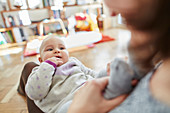 Mother holding baby daughter in lap