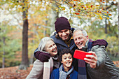 Family taking selfie in autumn woods