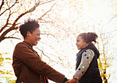 Affectionate mother and daughter holding hands