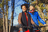 Smiling couple bike riding in autumn park