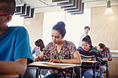 Female college student taking test at desk