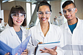 Portrait smiling college students in lab coats