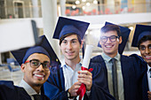 Male college graduates taking selfie