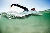 Male swimmer triathlete swimming in ocean