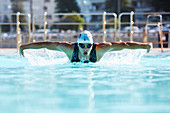 Male swimmer doing butterfly stroke swimming