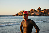 Male triathlete swimmer on ocean beach