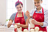 Smiling female caterers making cake pops
