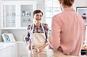 Smiling female caterers tying aprons