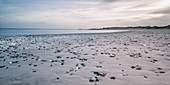 Rocks on tranquil grey beach, Vigsoe, Denmark