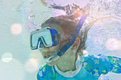 Close up girl snorkelling underwater