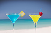 Blue and yellow cocktails on beach