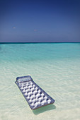 Inflatable raft floating on tranquil ocean