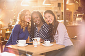 Portrait women friends drinking coffee