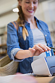 Female shopper using credit card reader