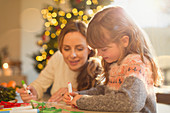 Mother and daughter making Christmas decorations