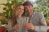 Smiling couple toasting champagne flutes