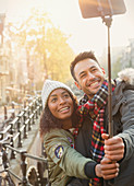 Young couple taking selfie on street