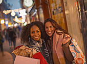 Young women friends with shopping bags