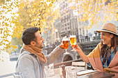 Young couple toasting beer glasses