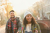 Laughing young couple walking