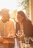 Young couple drinking white wine and in cafe