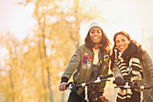 Young women friends bike riding