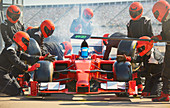 Pit crew working on formula one race car