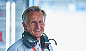 Formula one racing manager with headphones