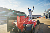 Formula one race car driver cheering