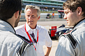 Manager talking to formula one drivers