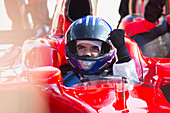 Formula one race car driver in helmet gesturing